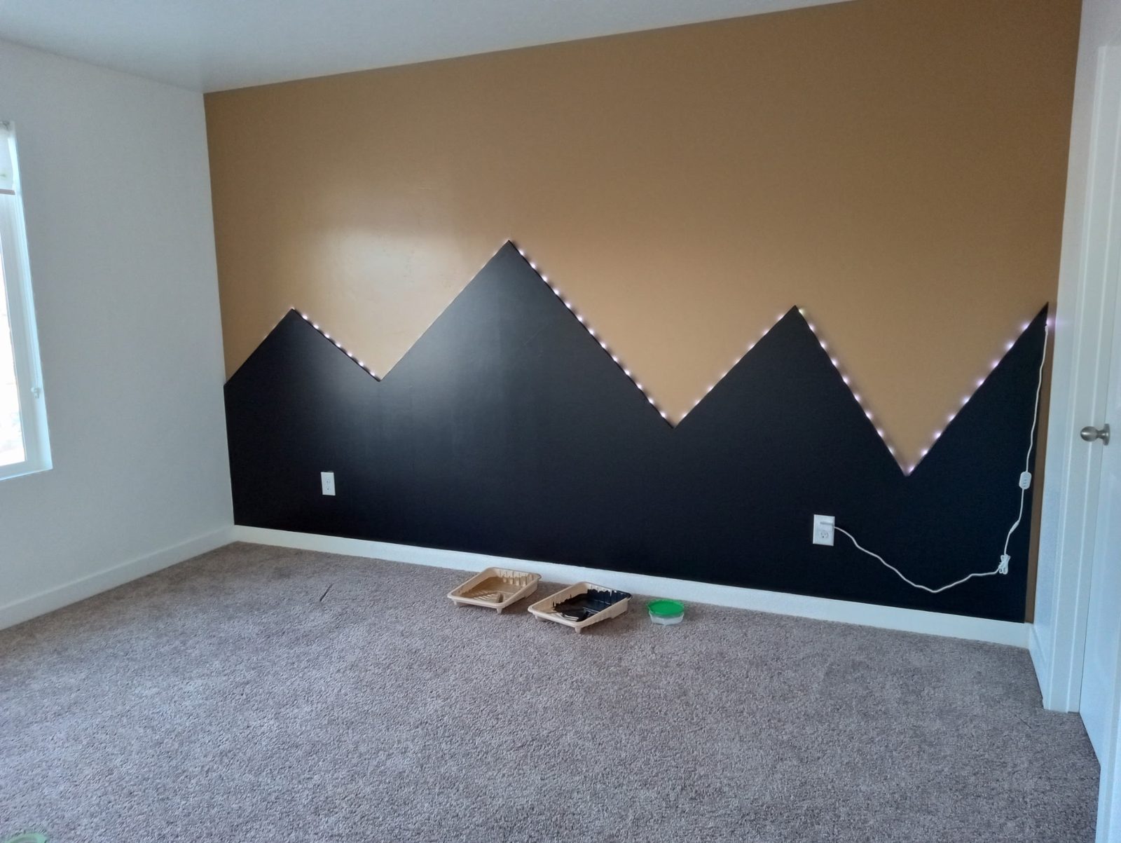 Navy mountain-silhouette painted feature wall in a Utah home