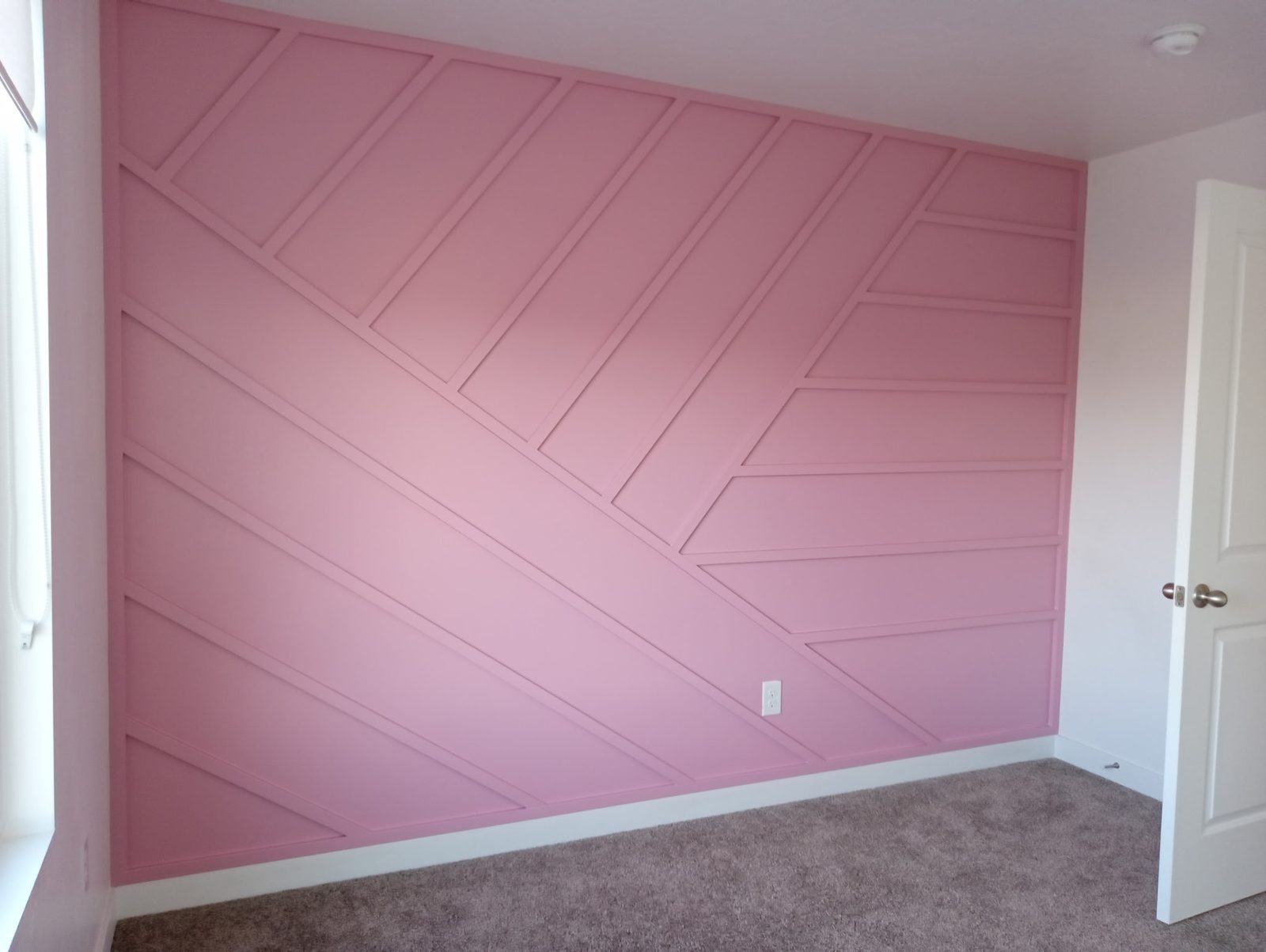 Pink geometric wainscoting in a Utah nursery