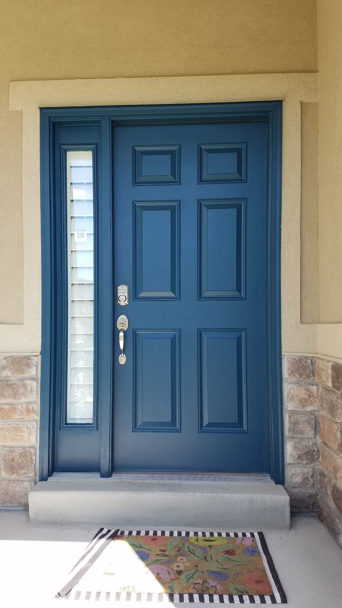 Blue front door on a Utah home with stone accents