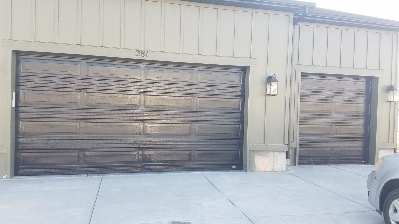 Olive-green siding home with new garage door paint in Utah