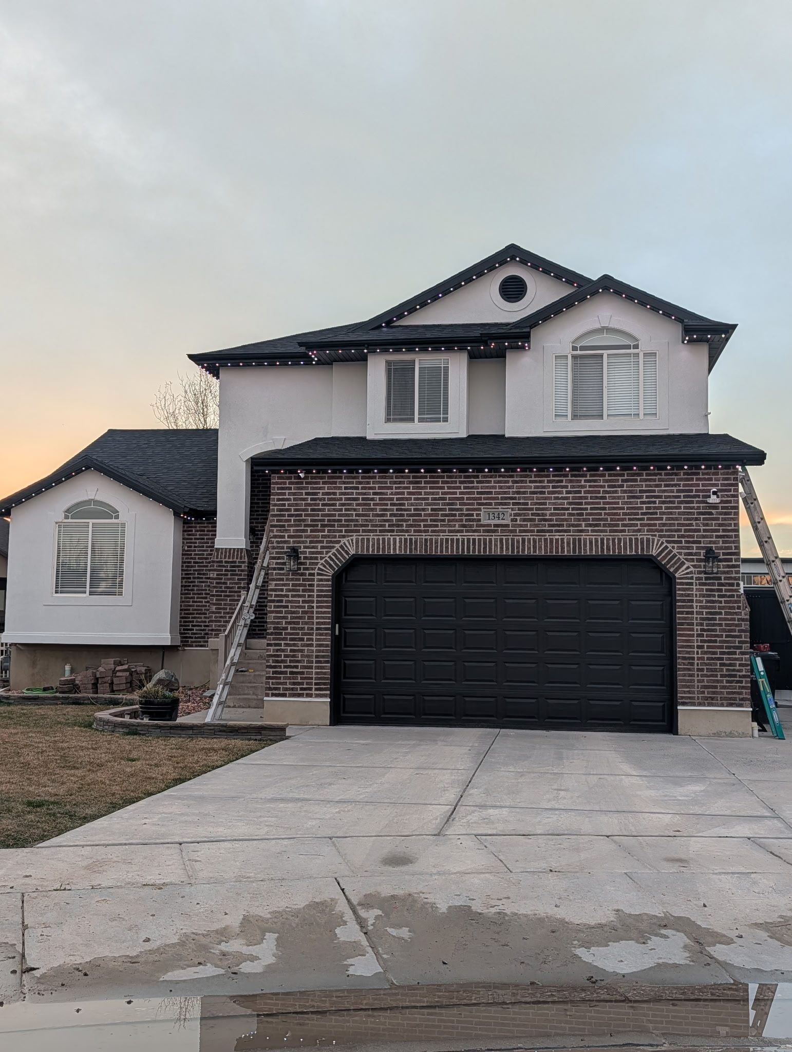 Two-story brick and stucco Utah home with fresh exterior paint on the Wasatch Front