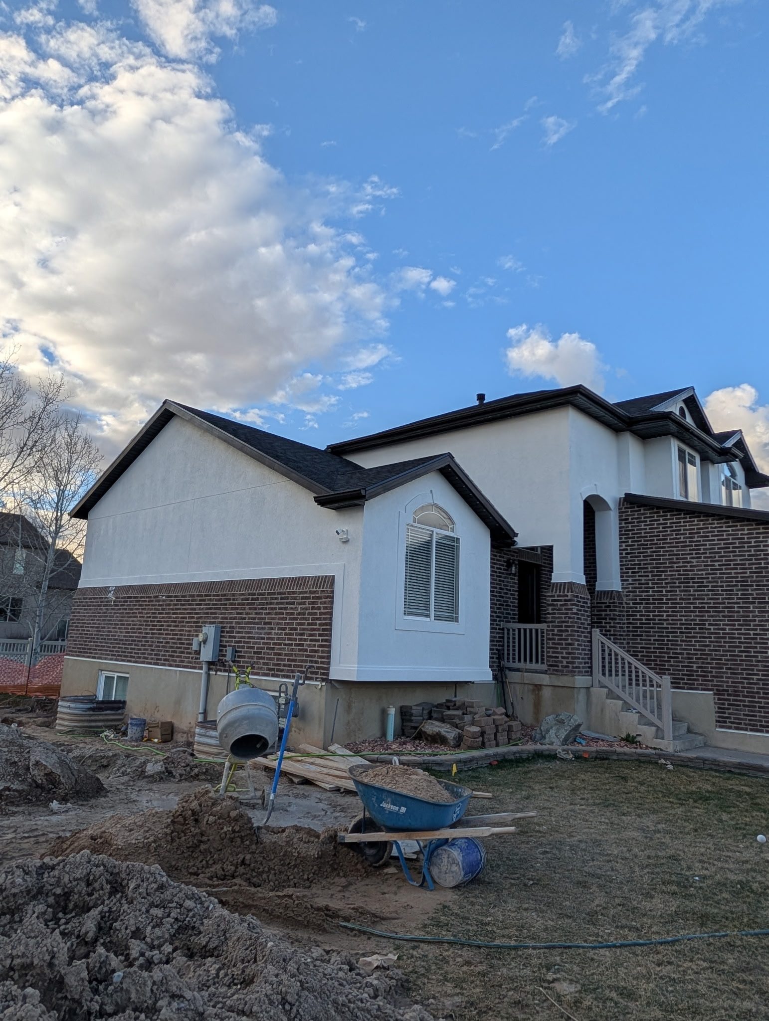White-trimmed Wasatch Front home with brick accents after exterior repaint