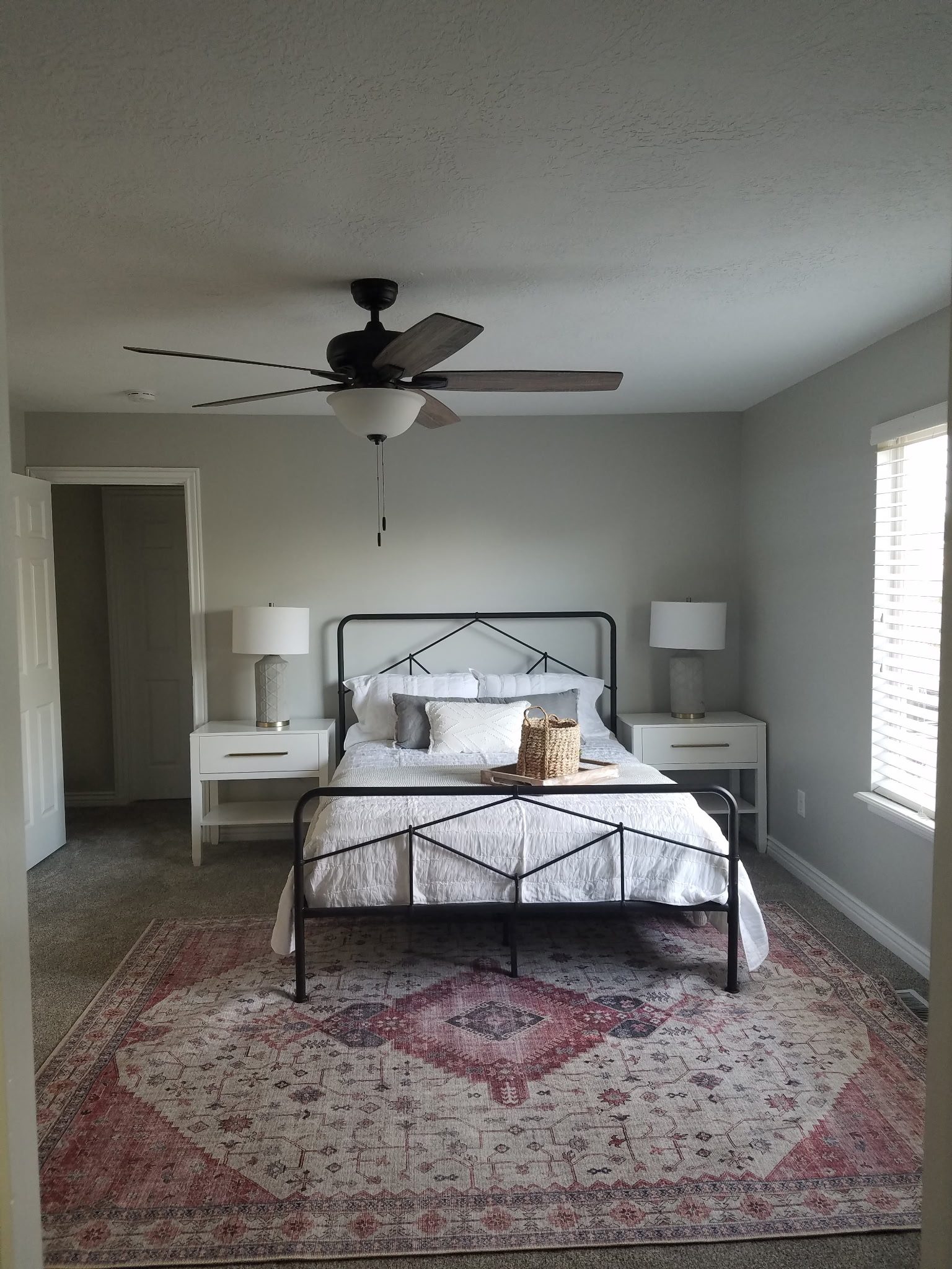 Bedroom with stained wood barn door in a Utah home