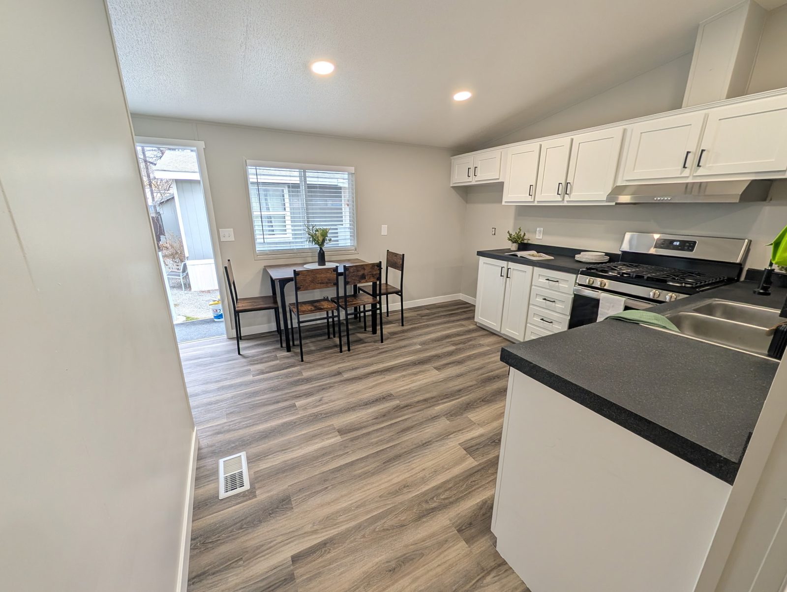 White kitchen and dining area with fresh interior paint in a Utah home