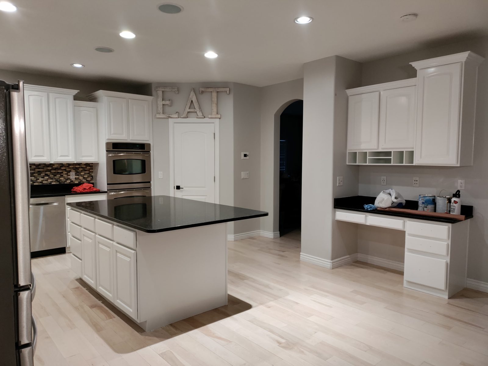 Painter at work on a kitchen repaint in Utah