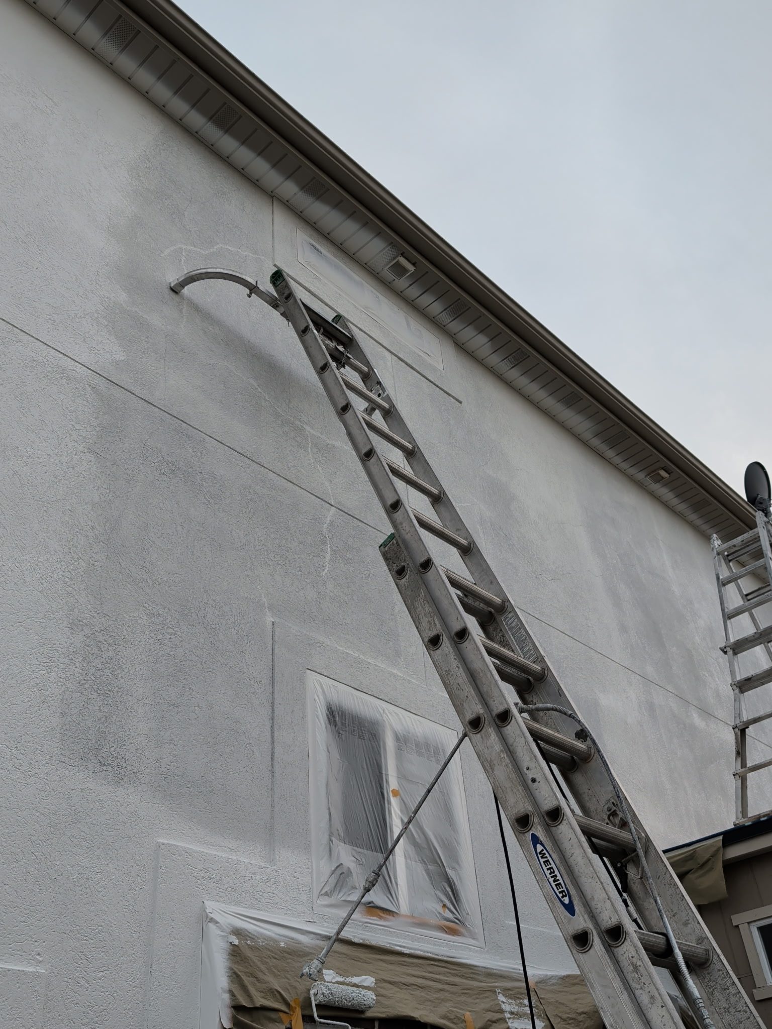 Jonathan Gonzalez and crew spraying stucco on a Utah home exterior